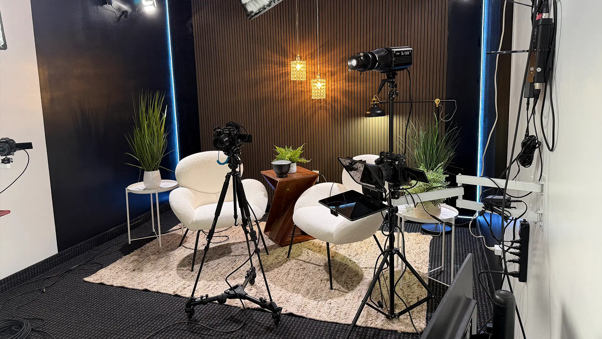 Professional podcast studio with cameras and lighting setup