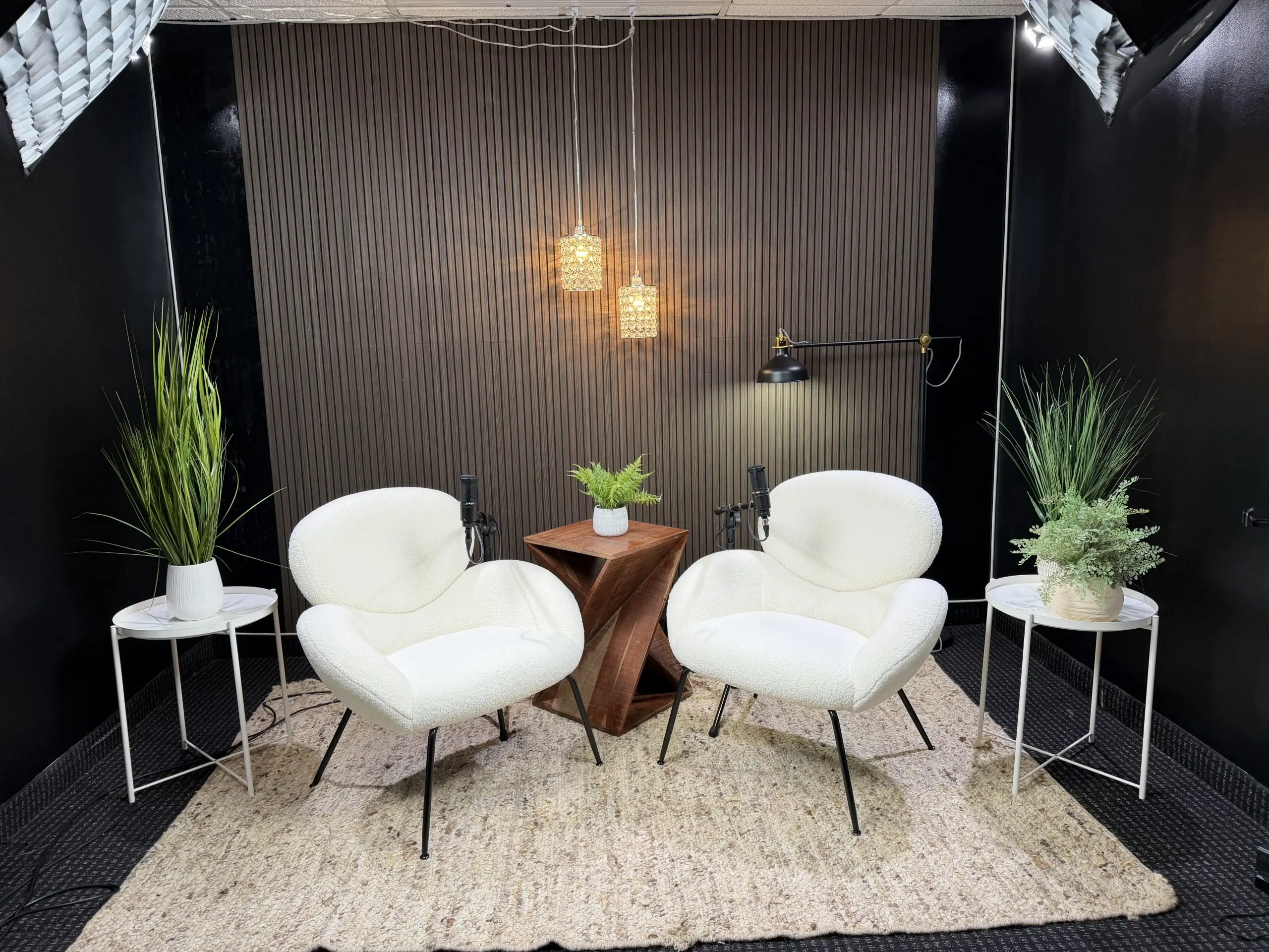 Modern podcast studio with two chairs and microphones