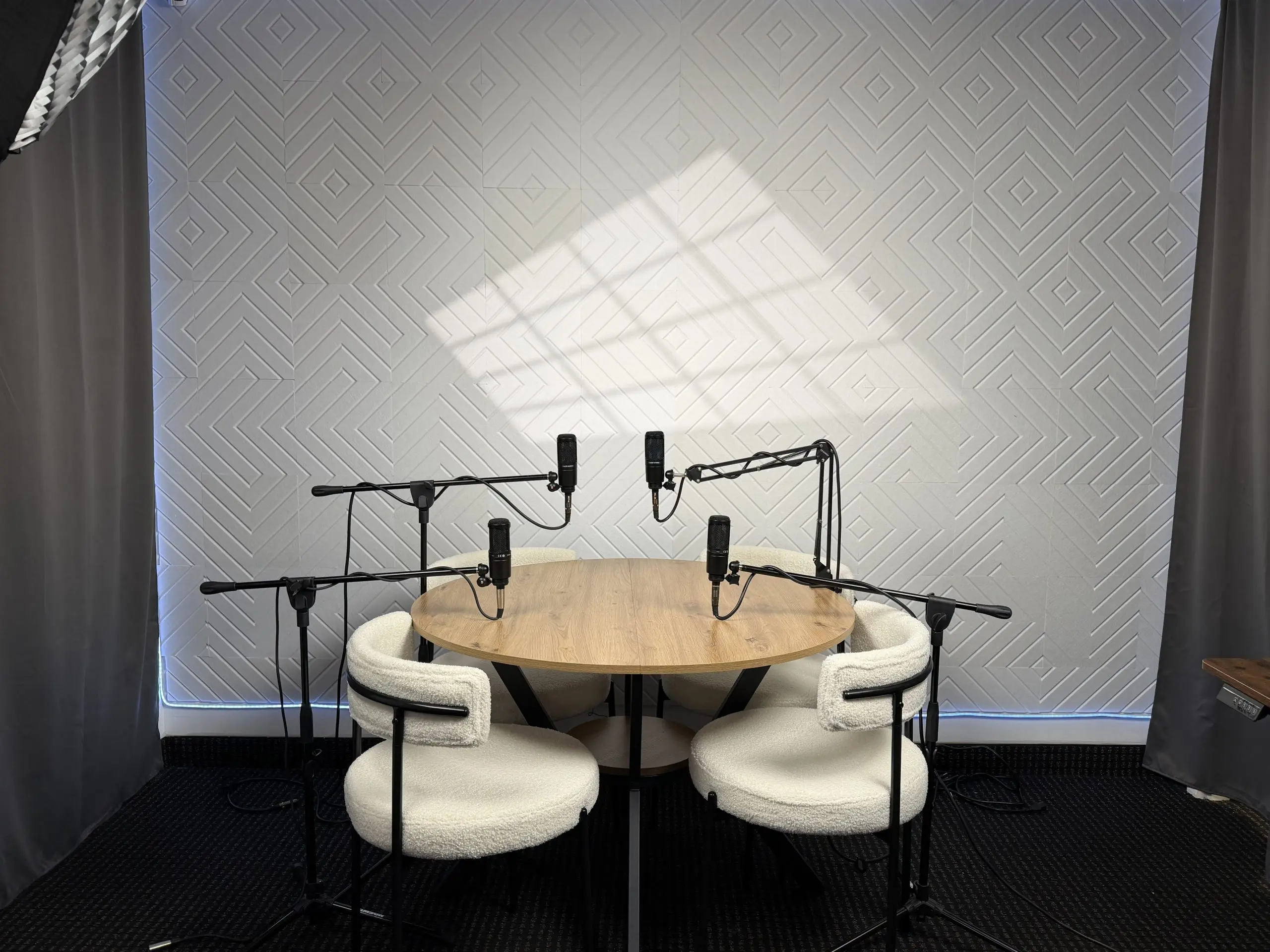 Podcast microphones and roundtable recording area