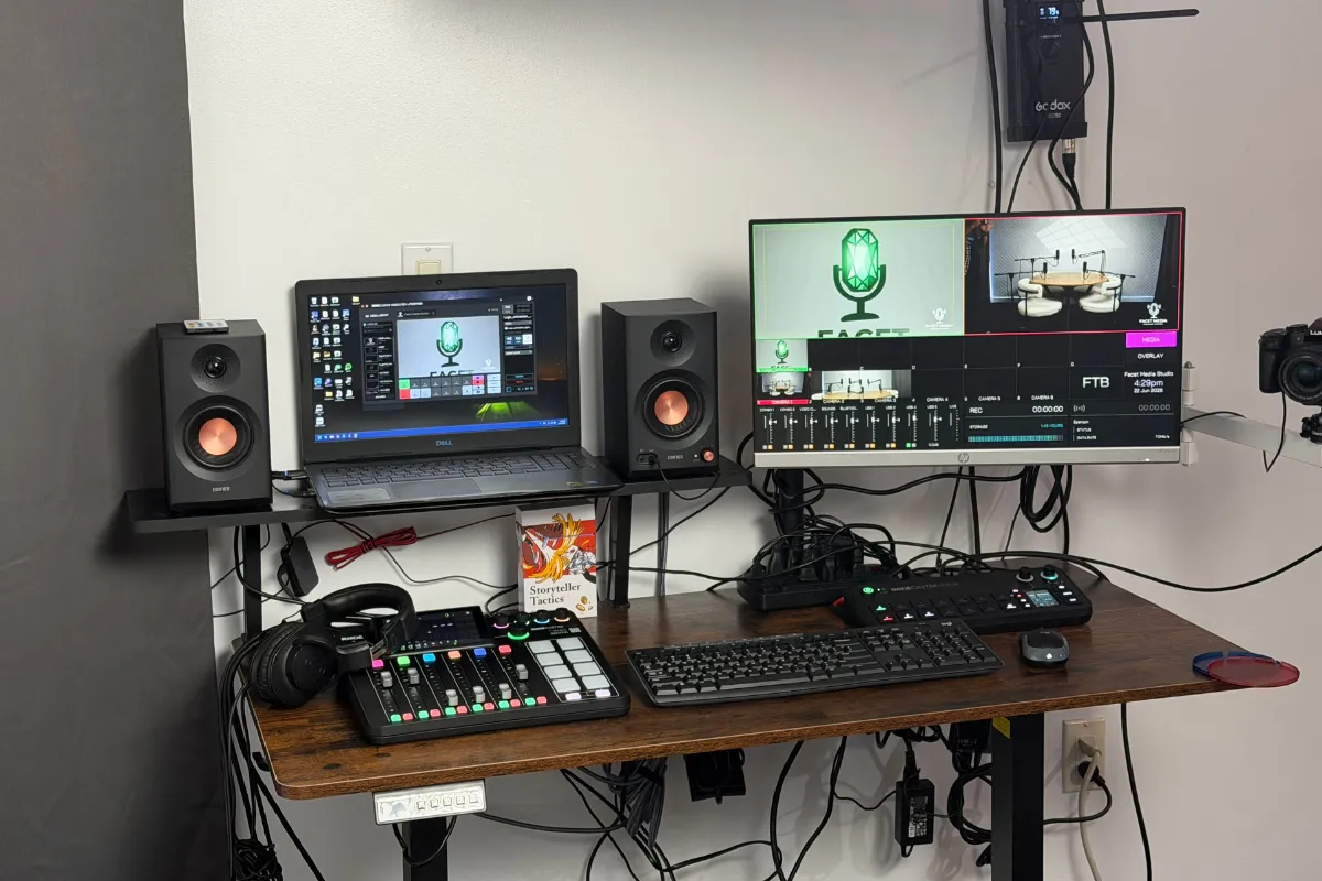 Podcast production desk with monitors and audio mixer