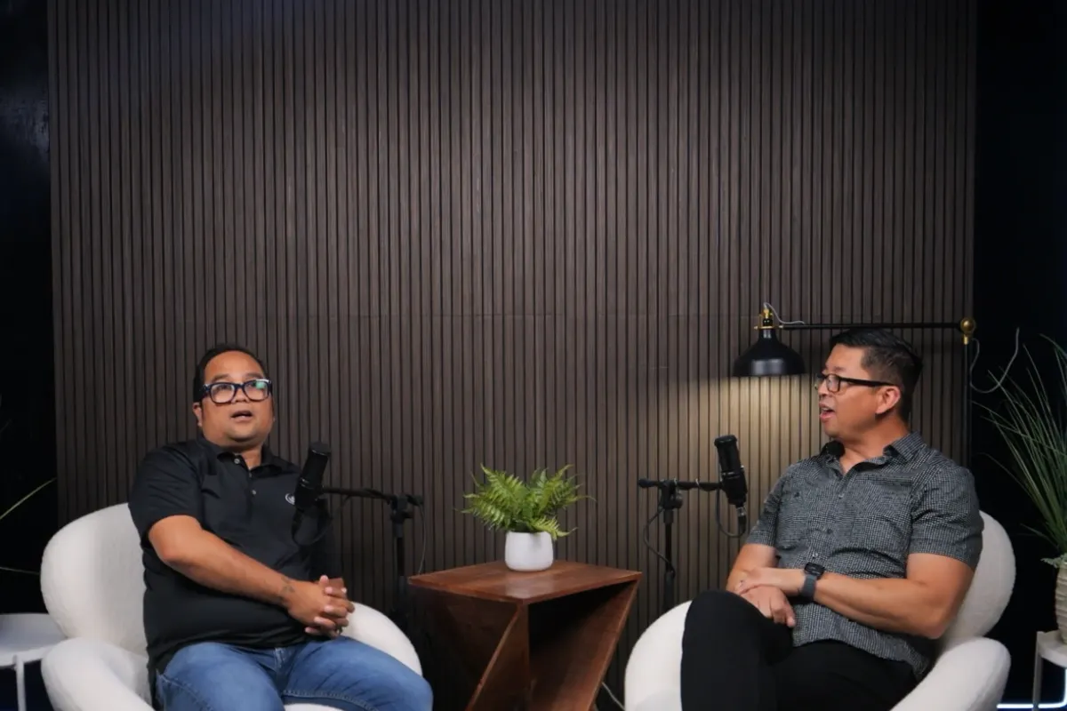 Two men discussing business during podcast interview