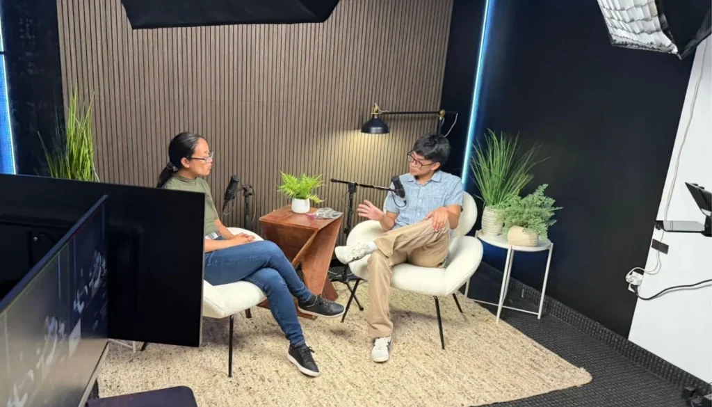 Two guests recording an interview in podcast studio